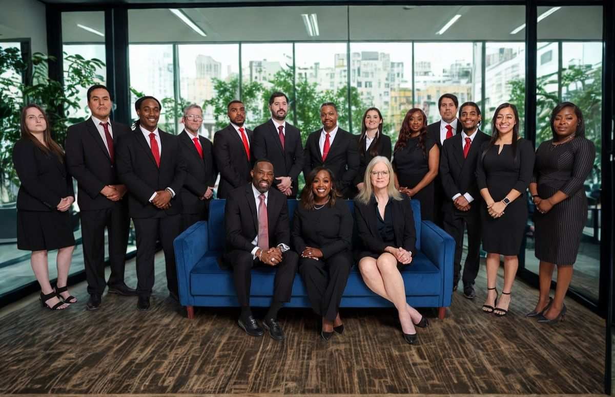 The L and L Law Group, PLLC criminal defense team — attorneys Njeri London and Reggie London with their full DFW staff at the firm's Frisco, Texas office